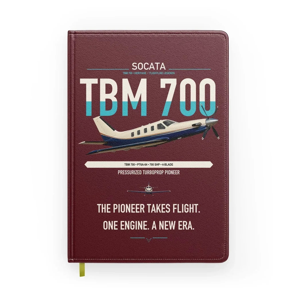 Socata TBM 700 design on dark red notebook