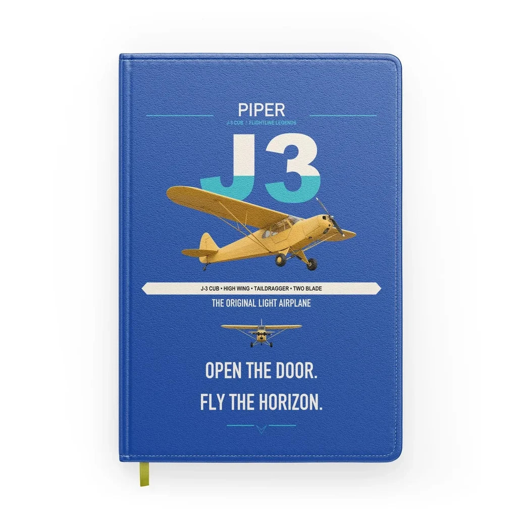 Piper J-3 Cub design on blue notebook
