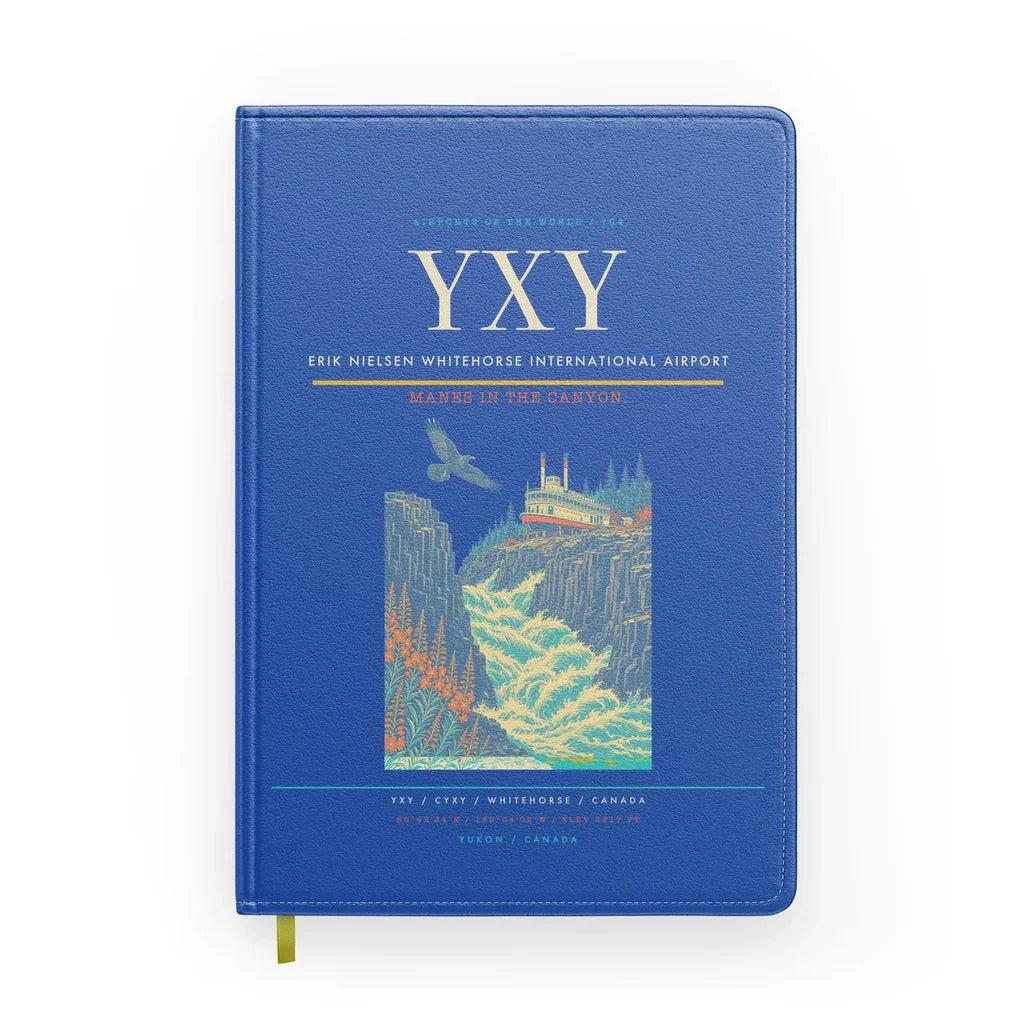 Erik Nielsen Whitehorse International Airport (YXY) design on blue notebook