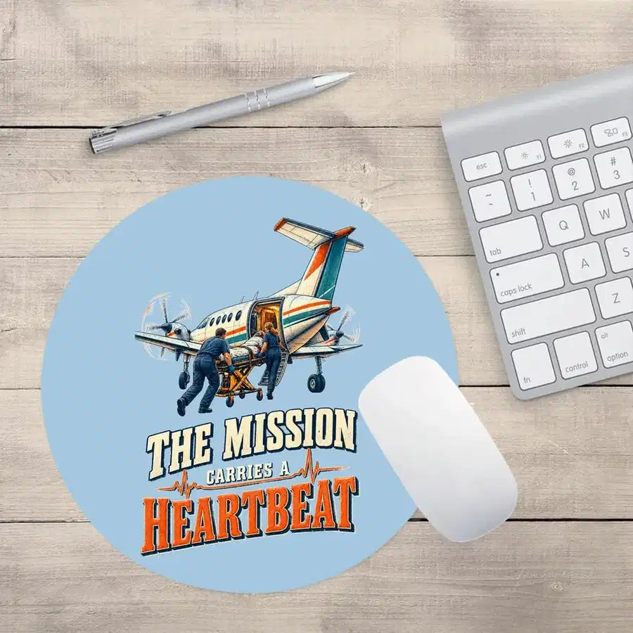 The Mission Carries A Heartbeat design on light blue round mouse pad