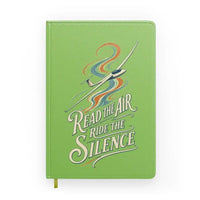 Thumbnail for Read The Air Ride The Silence design on light green notebook