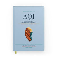 Thumbnail for King Hussein International Airport (AQJ) design on light blue notebook
