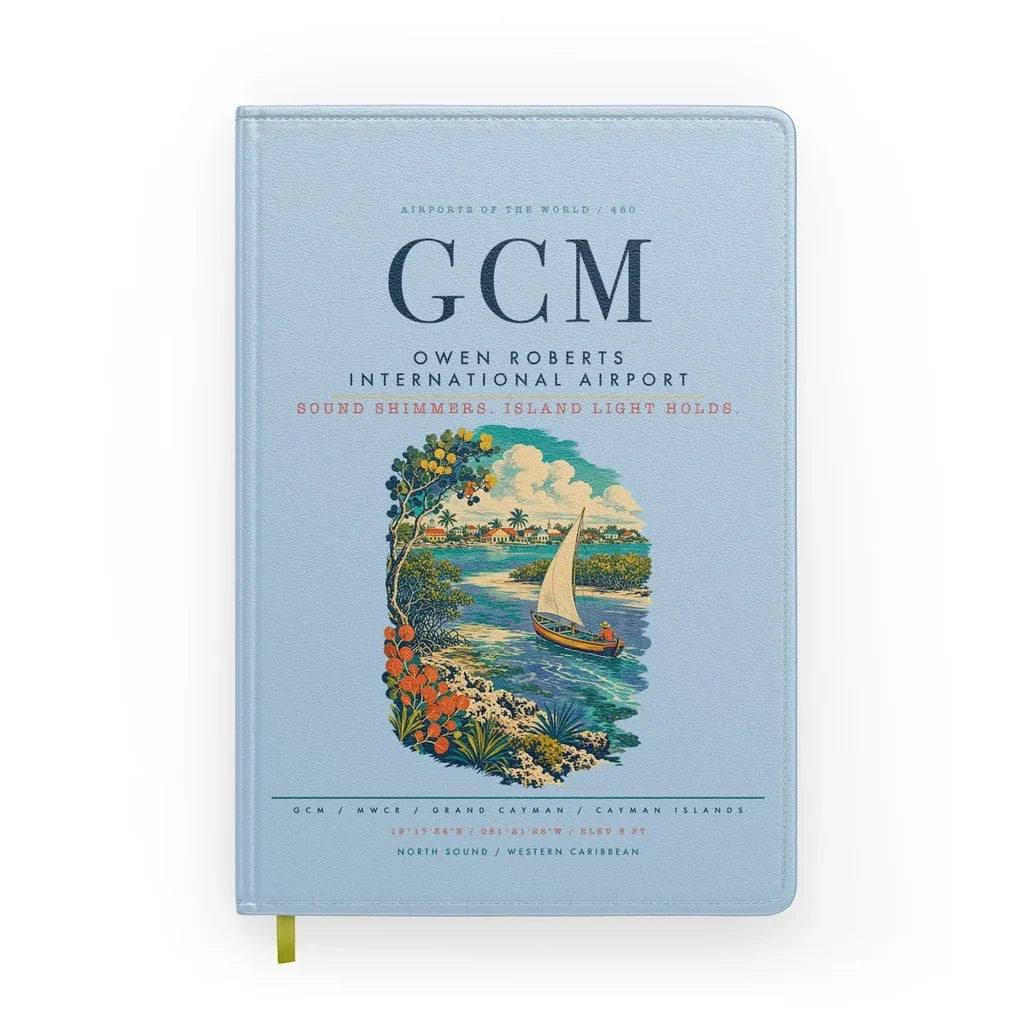 Owen Roberts International Airport (GCM) design on light blue notebook