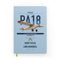 Thumbnail for Piper PA-18 Super Cub design on light blue notebook