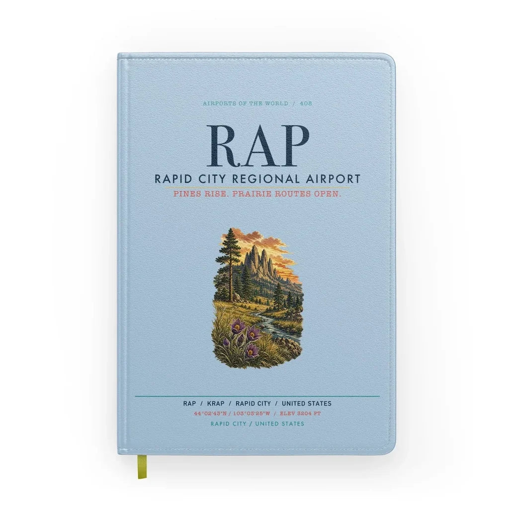 Rapid City Regional Airport (RAP) design on light blue notebook