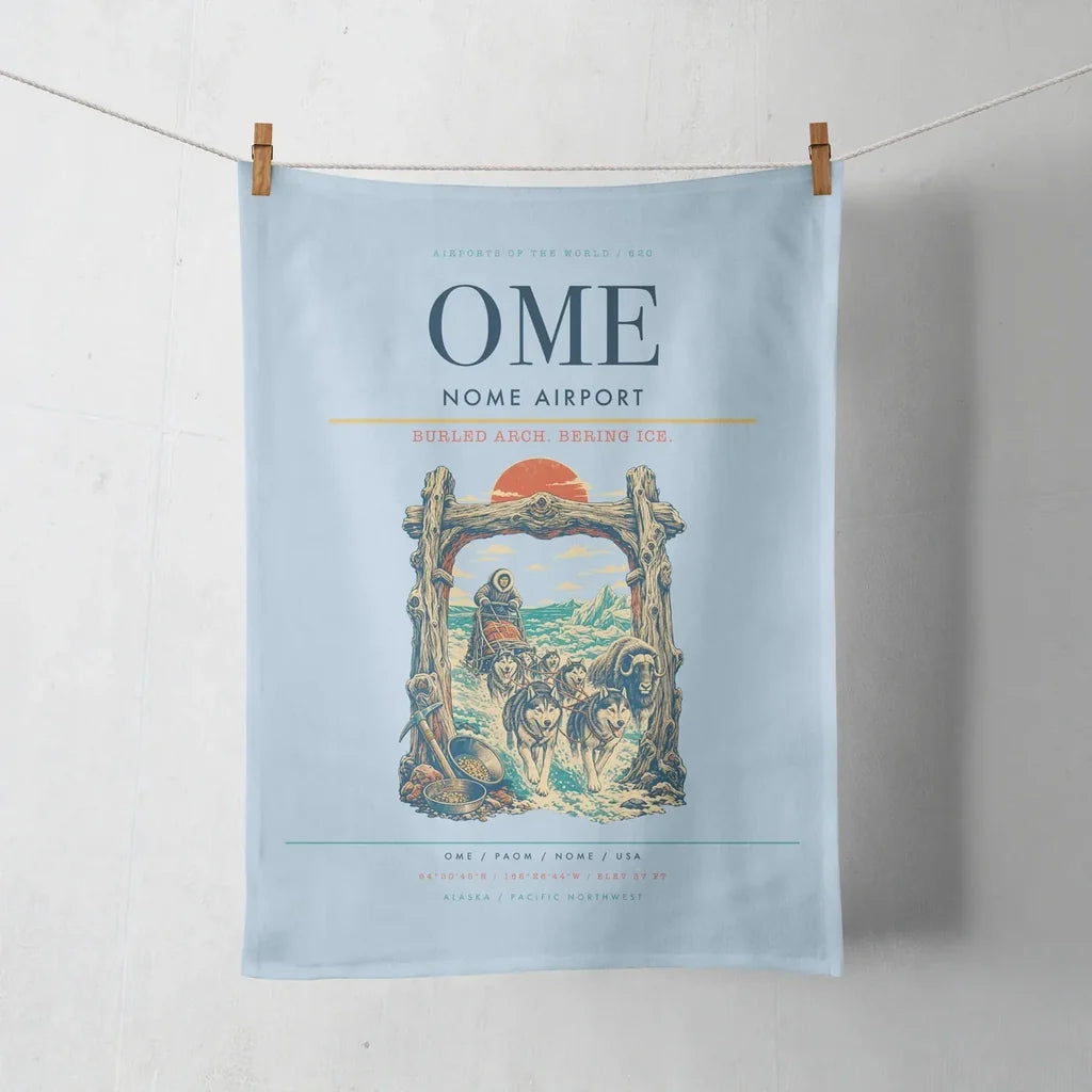 Nome Airport (OME) design on light blue towel