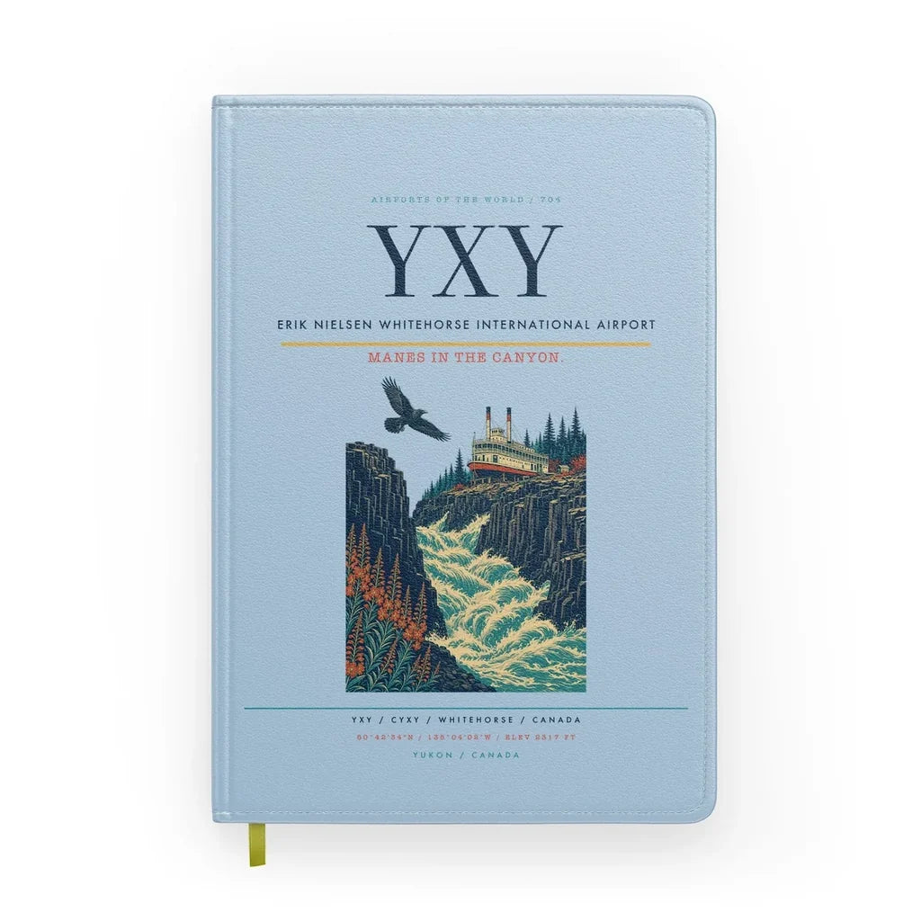 Erik Nielsen Whitehorse International Airport (YXY) design on light blue notebook
