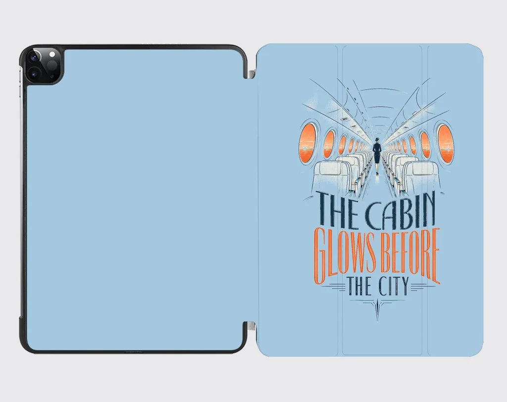 The Cabin Glows Before The City design on light blue ipad tablet case