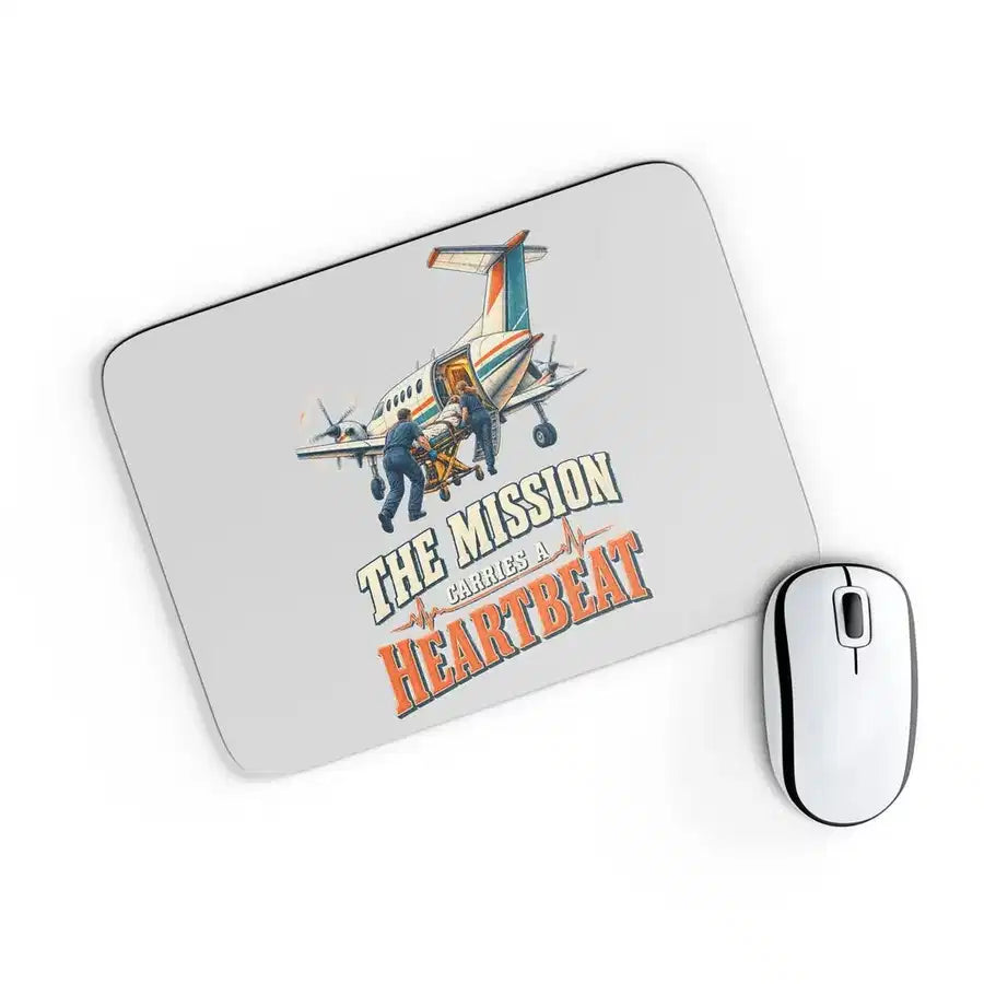 The Mission Carries A Heartbeat design on light gray rectangle mouse pad
