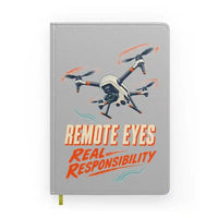 Thumbnail for Remote Eyes Real Responsibility design on light gray notebook