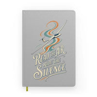Thumbnail for Read The Air Ride The Silence design on light gray notebook