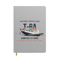 Thumbnail for T-6A Texan II Train The Next Generation design on light gray notebook