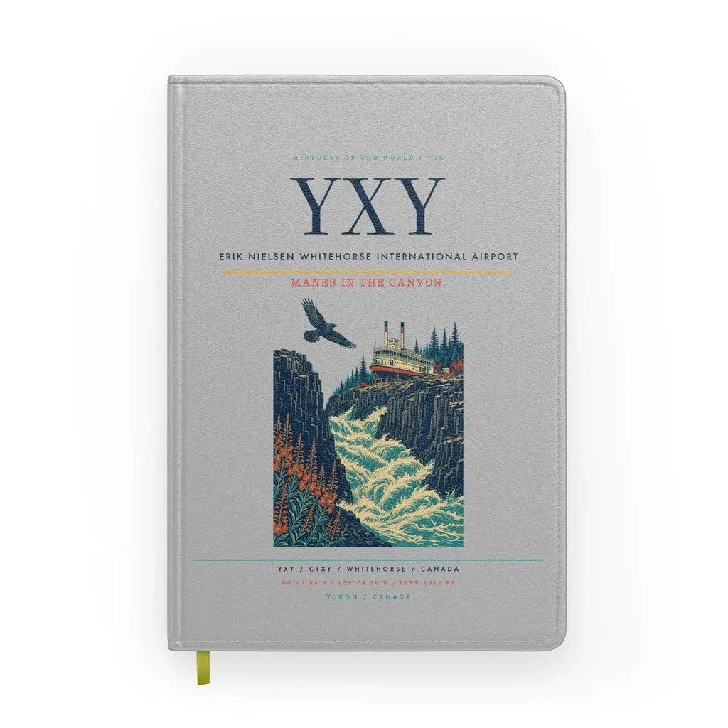 Erik Nielsen Whitehorse International Airport (YXY) design on light gray notebook