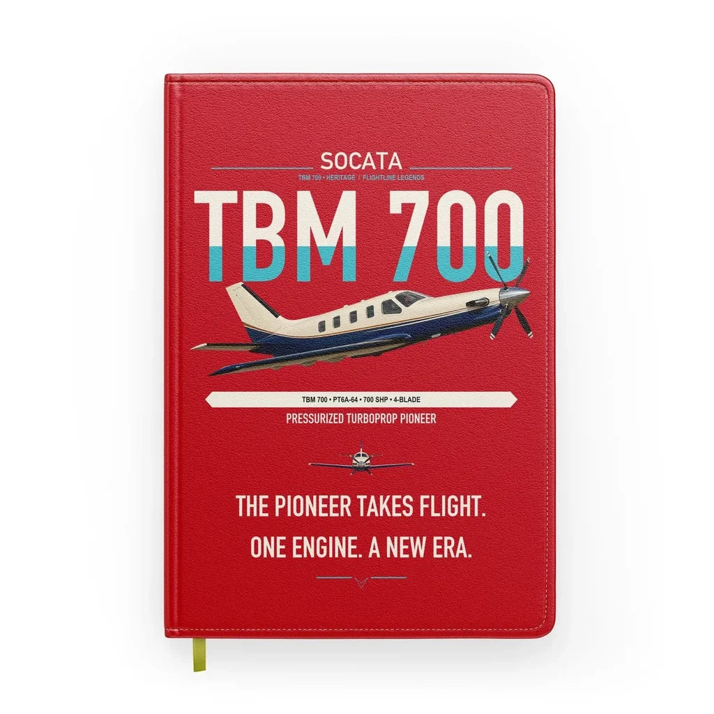 Socata TBM 700 design on red notebook