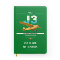 Thumbnail for Piper J-3 Cub design on green notebook