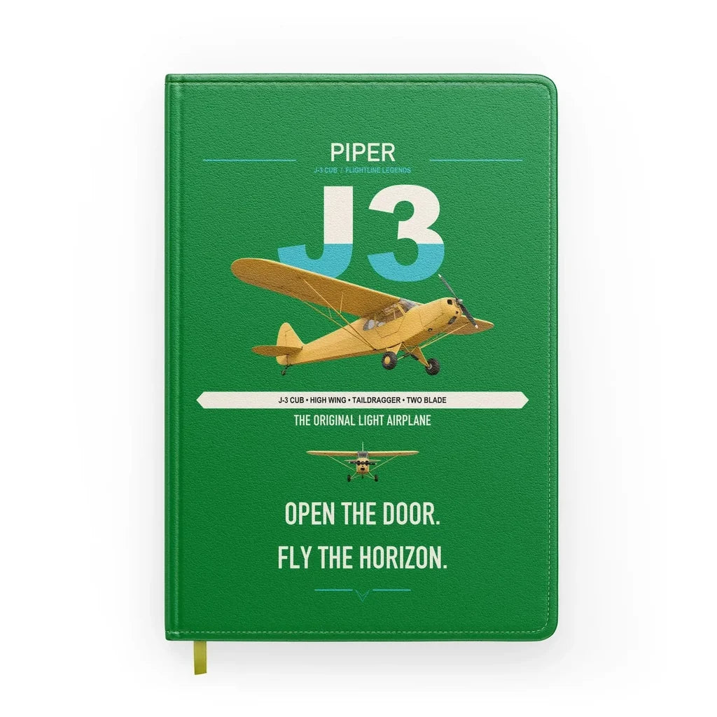 Piper J-3 Cub design on green notebook