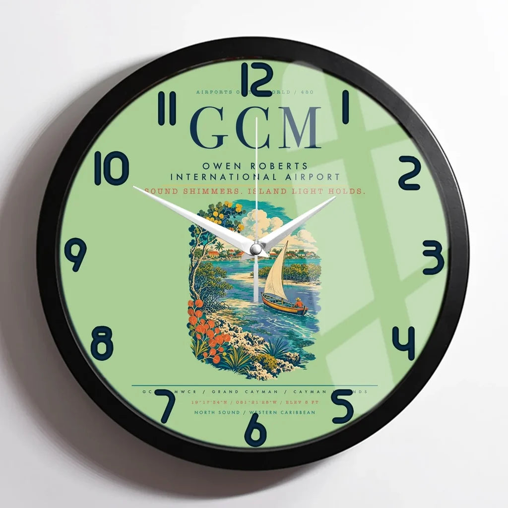 Owen Roberts International Airport (GCM) design on light green framed wall clock