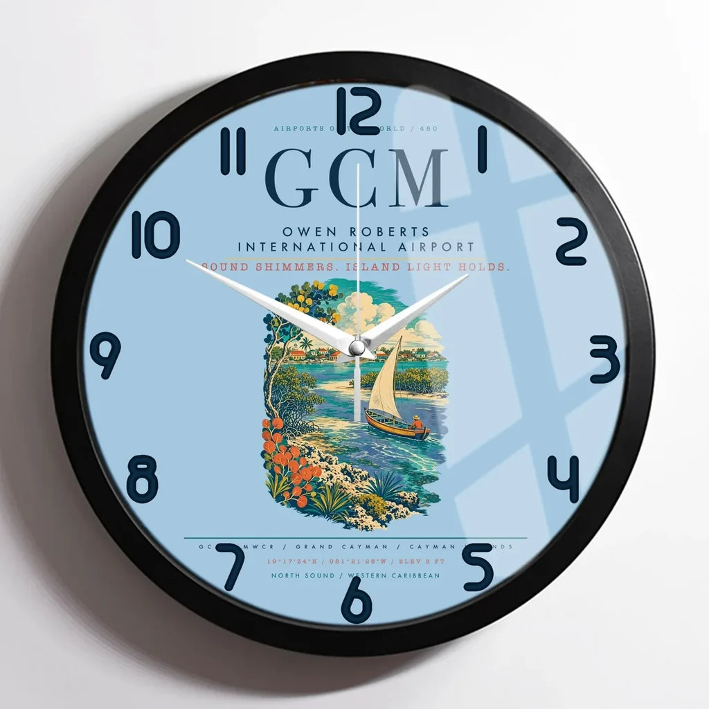 Owen Roberts International Airport (GCM) design on light blue framed wall clock