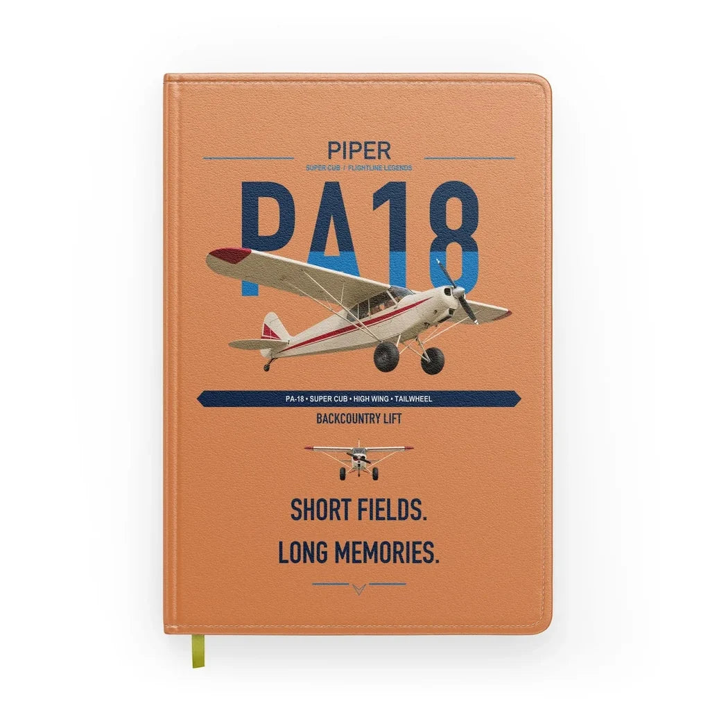 Piper PA-18 Super Cub design on orange notebook