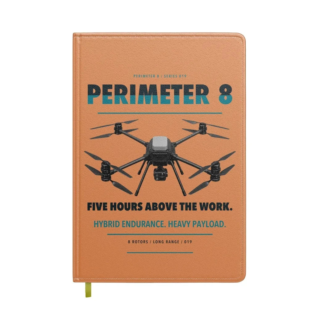 Skyfront Perimeter 8 design on orange notebook