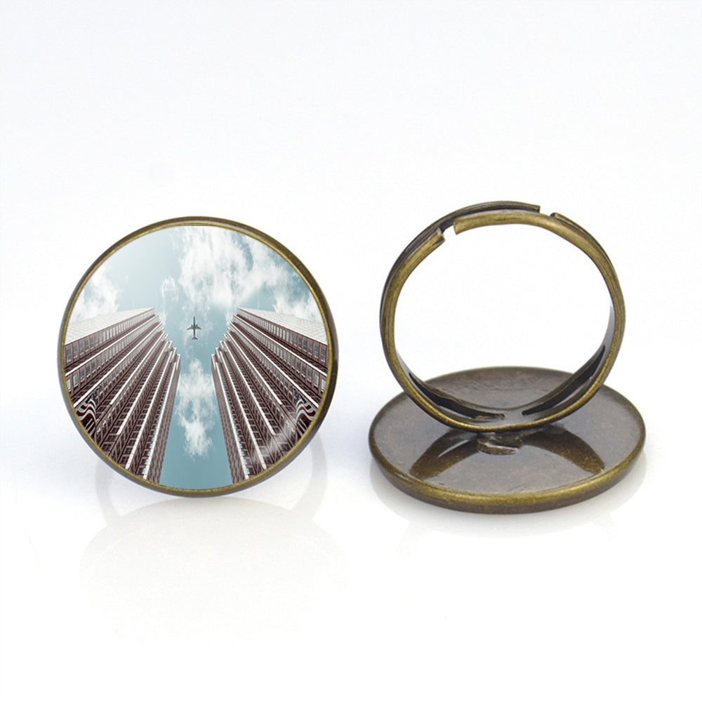 Airplane Flying over Big Buildings Designed Rings