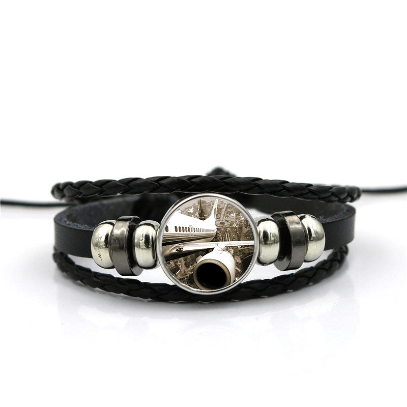 Departing Aircraft & City Scene behind Designed Leather Bracelets