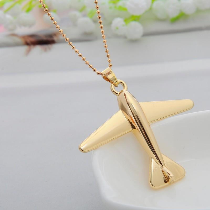 gold necklace with airplane pendant
